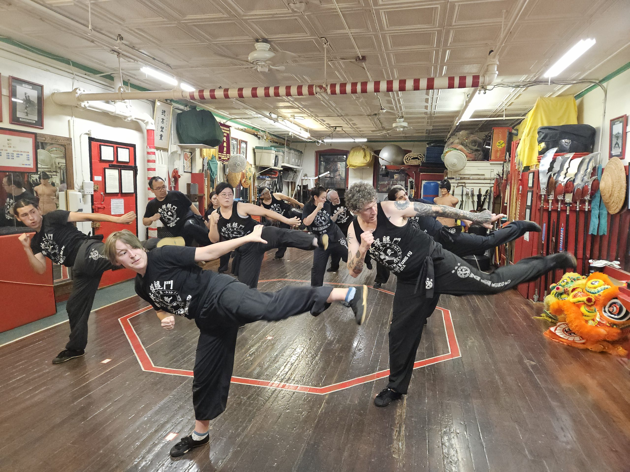 Students practicing kicking techniques during a group class